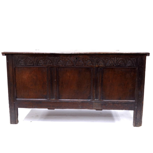 350 - A 17th Century country oak plank chest, circa 1660, moulded and chip carved top and sides with chevr... 