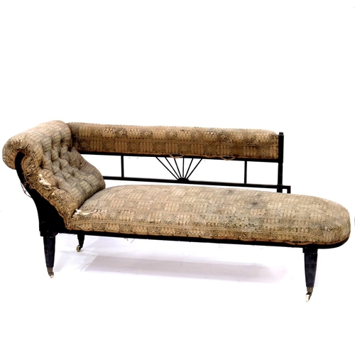 367 - An Aesthetic Movement ebonised chaise longue, circa 1880, Anglo Egyptian style, with angled and spin... 