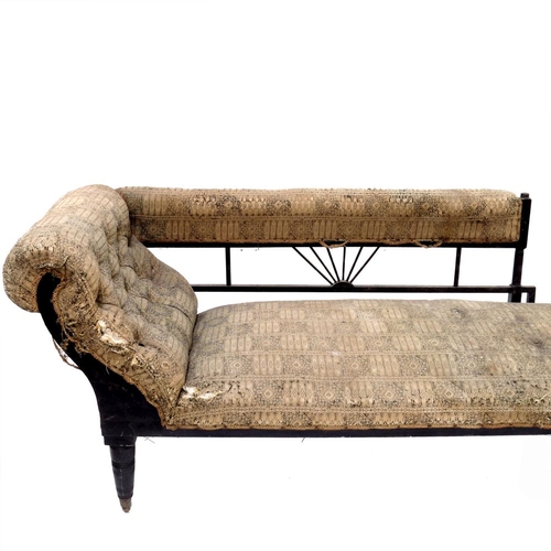 367 - An Aesthetic Movement ebonised chaise longue, circa 1880, Anglo Egyptian style, with angled and spin... 