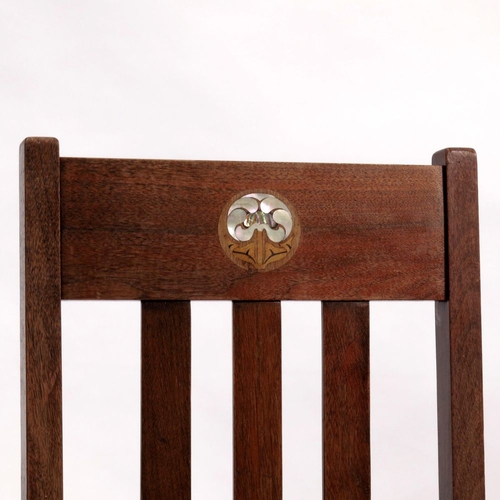 377 - A pair of Mission style Arts and Crafts chairs, the slatted backs inlaid with stylised mother of pea... 