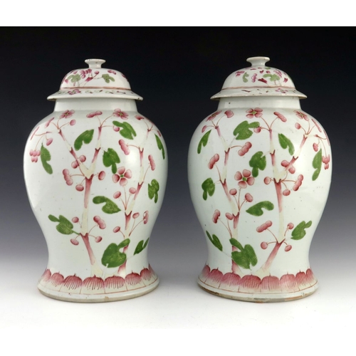 428 - A pair of Chinese famille rose temple jars and covers, Qing, 19th century, inverse baluster form wit... 