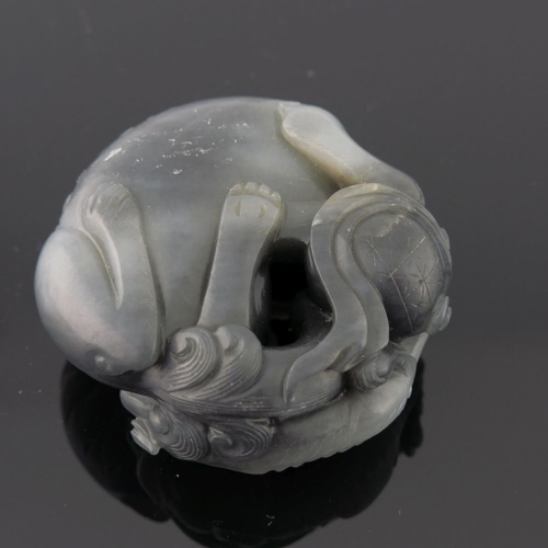 469 - A Chinese black and white jade pendant carving, in the form of large and small shi-shi, diameter 5cm