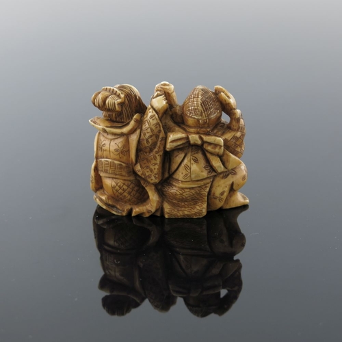 504 - λ A Japanese ivory netsuke, Meiji period, 1868-1912, carved as a fisherman and lady companion taking... 