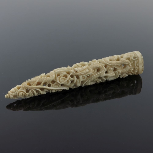 509 - λ A Japanese ivory small tusk carving, Meiji period, 1868-1912, reticulated dragon amongst scrollwor... 