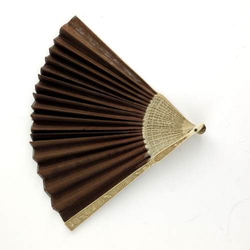 518 - λ A small Chinese export fan, early 19th century, with carved ivory sticks and plain silk leaf, the ... 