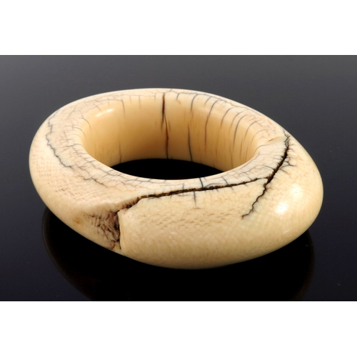 519 - λ An African tribal ivory bangle bracelet, unusually large and heavy, 255 grams, 12cm widest