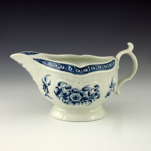 1171 - A Worcester blue and white relief moulded sauce boat, circa 1775, crescent mark, painted in the Stra... 