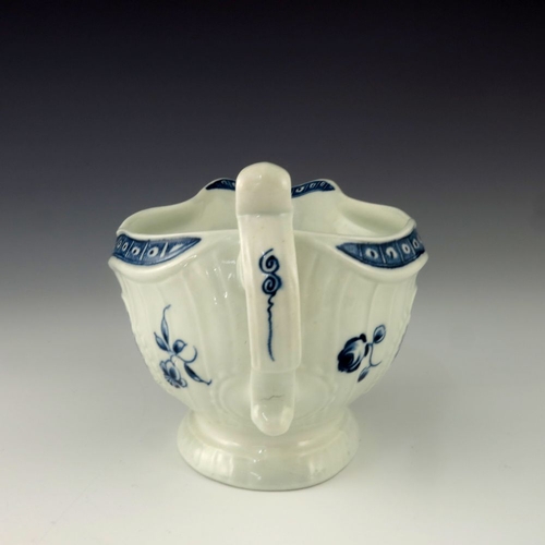 1171 - A Worcester blue and white relief moulded sauce boat, circa 1775, crescent mark, painted in the Stra... 