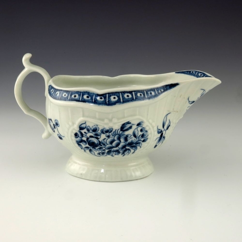 1171 - A Worcester blue and white relief moulded sauce boat, circa 1775, crescent mark, painted in the Stra... 