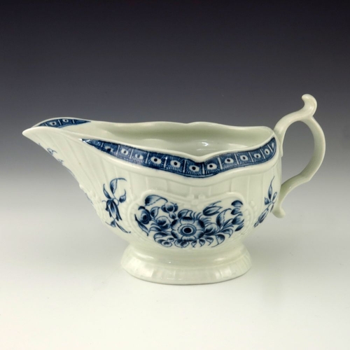 1171 - A Worcester blue and white relief moulded sauce boat, circa 1775, crescent mark, painted in the Stra... 