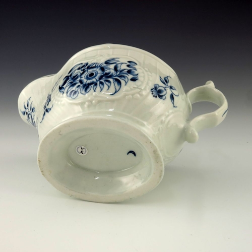 1171 - A Worcester blue and white relief moulded sauce boat, circa 1775, crescent mark, painted in the Stra... 