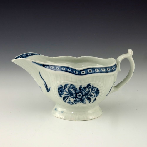 1172 - A Worcester blue and white relief moulded sauce boat, circa 1775, crescent mark, painted in the Stra... 