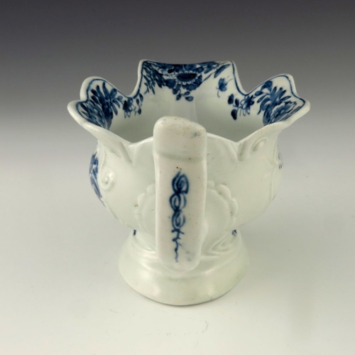 1175 - A Worcester blue and white relief moulded sauce boat, circa 1755, workman's mark, painted in the Tri... 