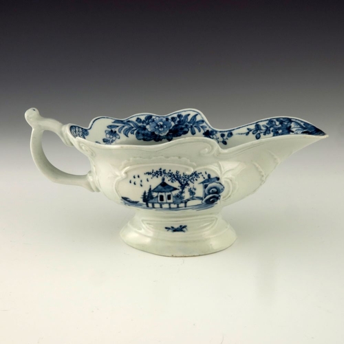 1175 - A Worcester blue and white relief moulded sauce boat, circa 1755, workman's mark, painted in the Tri... 