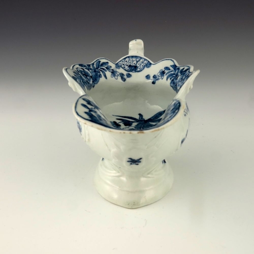 1175 - A Worcester blue and white relief moulded sauce boat, circa 1755, workman's mark, painted in the Tri... 