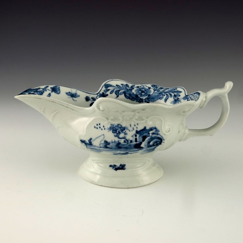 1175 - A Worcester blue and white relief moulded sauce boat, circa 1755, workman's mark, painted in the Tri... 