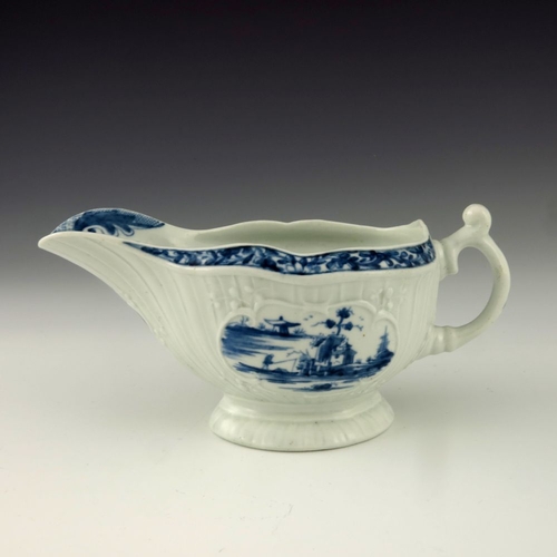 1176 - A Worcester blue and white relief moulded sauce boat, circa 1760, workman's mark, painted with the F... 