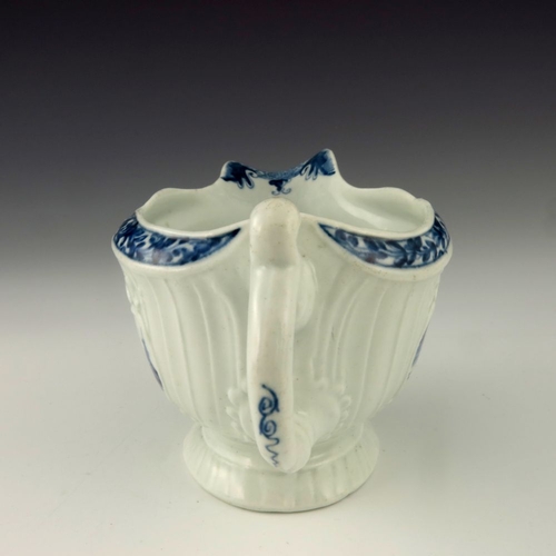 1176 - A Worcester blue and white relief moulded sauce boat, circa 1760, workman's mark, painted with the F... 