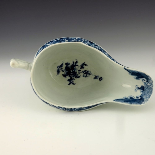 1176 - A Worcester blue and white relief moulded sauce boat, circa 1760, workman's mark, painted with the F... 