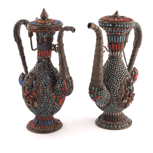 5 - A pair of Persian white metal and jewelled ewers, footed baluster form with S scroll handles and sca... 