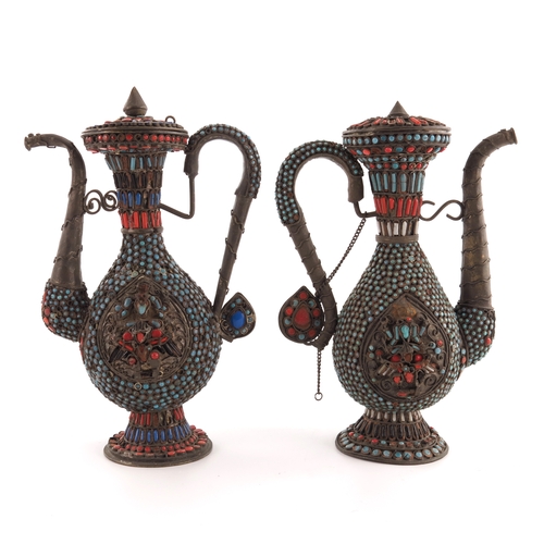 5 - A pair of Persian white metal and jewelled ewers, footed baluster form with S scroll handles and sca... 