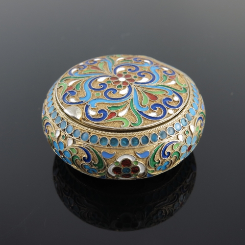 21 - A Russian silver gilt snuff box, of circular form with scroll decoration, struck Kokoshnik mark and ... 