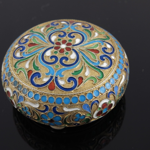 21 - A Russian silver gilt snuff box, of circular form with scroll decoration, struck Kokoshnik mark and ... 