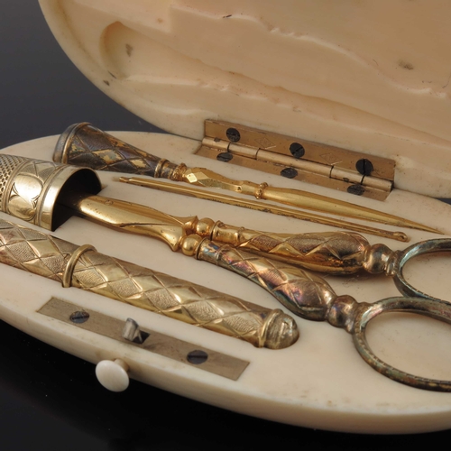 32 - A 19th century French silver gilt and ivory cased sewing set, the oval box fitted with scissors, thi... 