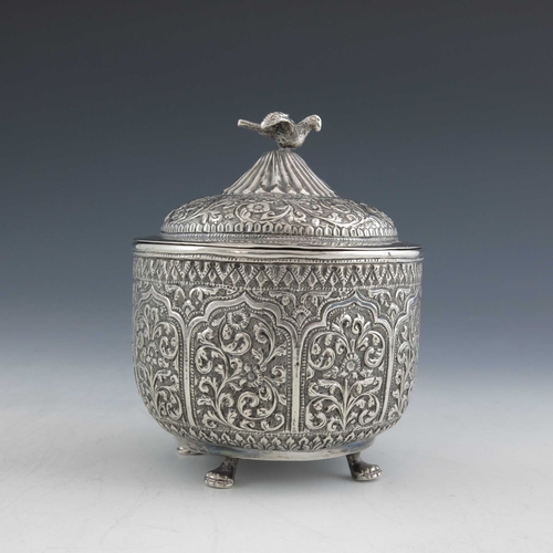 7 - An Indian Kutch silver box and cover, or tea caddy, 19th century, rounded bowl form, repousse emboss... 