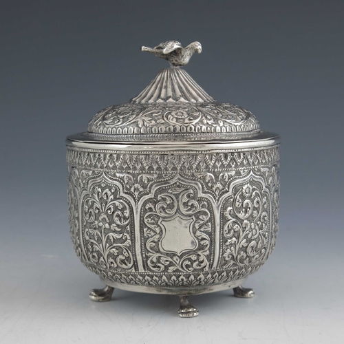 7 - An Indian Kutch silver box and cover, or tea caddy, 19th century, rounded bowl form, repousse emboss... 