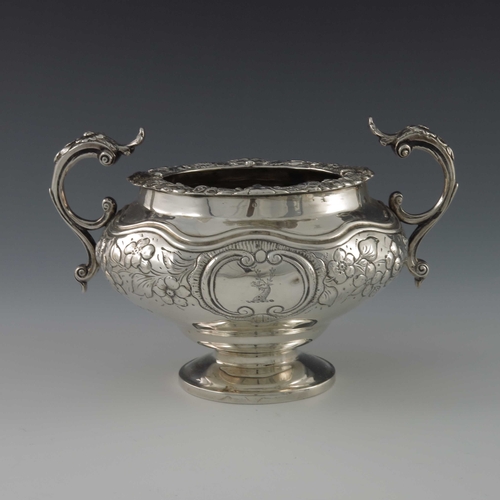 53 - A George IV silver three piece tea set, William Hunter, London 1826, footed ogee ovoid form, embosse... 