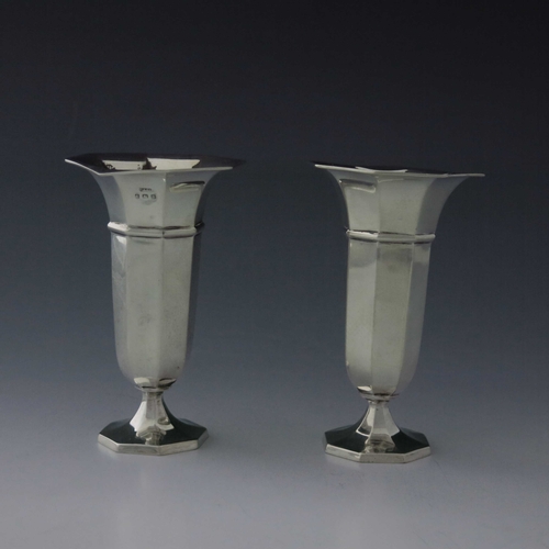 80 - A pair of George V silver vases, A & J Zimmerman, Birmingham 1912, octagonal section, banded and foo... 