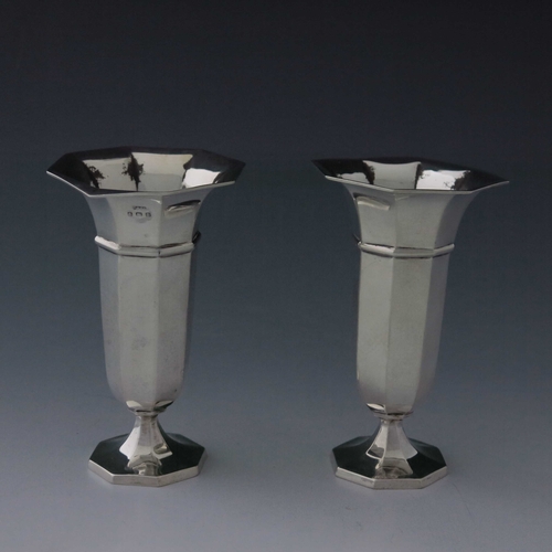 80 - A pair of George V silver vases, A & J Zimmerman, Birmingham 1912, octagonal section, banded and foo... 