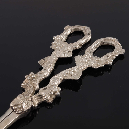 81 - A pair of Edwardian cast silver grape scissors, William Hutton and Sons, London 1901, the handles mo... 