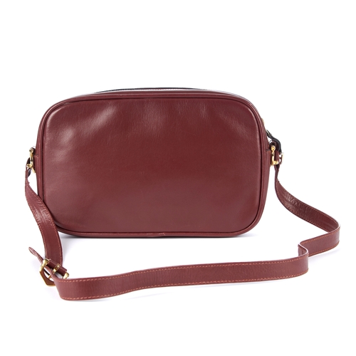 26 - Cartier, a vintage Bordeaux leather camera bag, crafted from smooth burgundy leather, featuring make... 