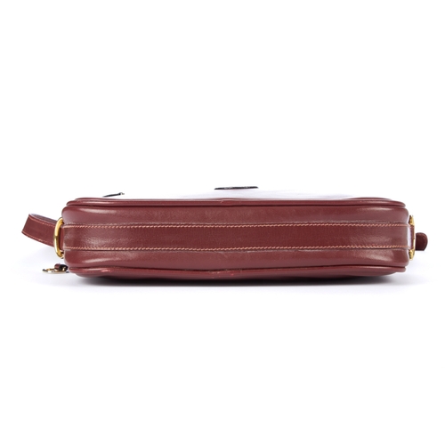 26 - Cartier, a vintage Bordeaux leather camera bag, crafted from smooth burgundy leather, featuring make... 