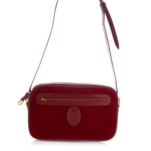 27 - Cartier, a vintage Bordeaux camera bag, crafted from burgundy suede with smooth burgundy leather tri... 