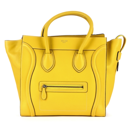 33 - Celine, a Mini Luggage tote, designed with a grained yellow leather exterior, featuring expandable l... 