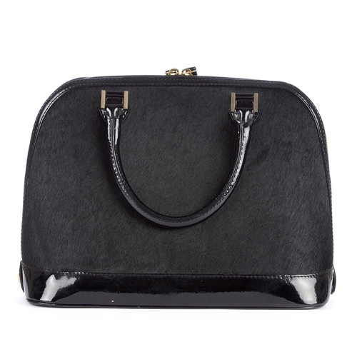 9 - Aspinal of London, a Hepburn handbag, designed with a black pony hair exterior and black patent leat... 