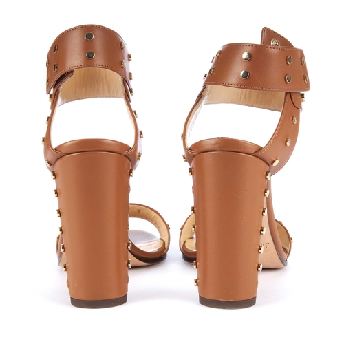 190 - Jimmy Choo, a pair of Veto studded heeled sandals, crafted from tan leather with gold-tone stud embe... 