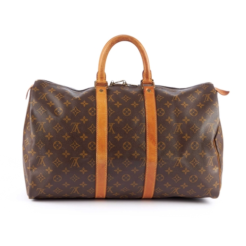 206 - Louis Vuitton, a monogram Keepall 45 luggage bag, designed with vachetta natural leather trim, rolle... 
