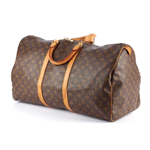 212 - Louis Vuitton, a monogram Keepall 55 luggage bag, featuring the maker's classic monogram coated canv... 