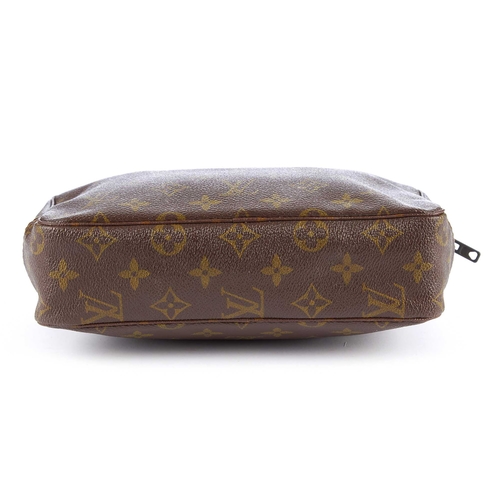 221 - Louis Vuitton, a monogram Toiletry PM pouch, featuring a top zip fastening and washable beige interi... 