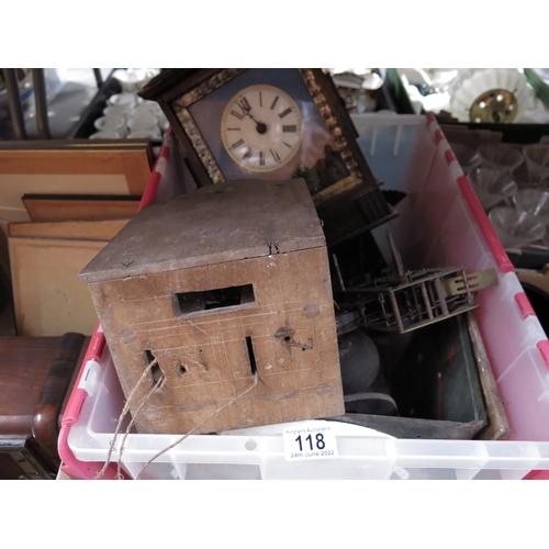 118 - A brass spring driven clock mechanism, circa 1900,  together with two enamelled clock faces, wooden ... 