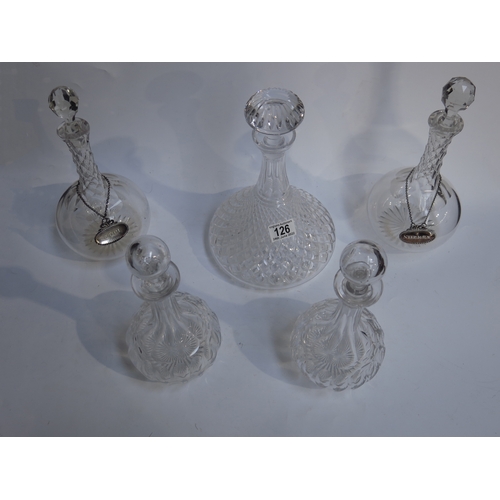 126 - Five cut glass spirit decanters, two plated wine labels and a blue flashed glass vase (6)