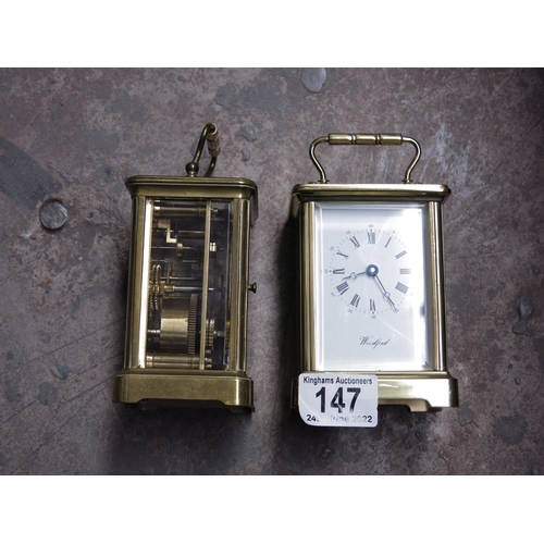 147 - Two gilt brass carriage timepieces, one marked Woodford.  (2)