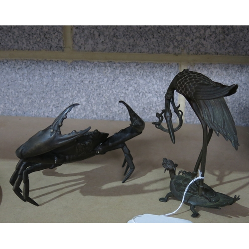 174 - A bronze figure of a crab, together with a Japanese bronze figure group of a stork and standing on a... 