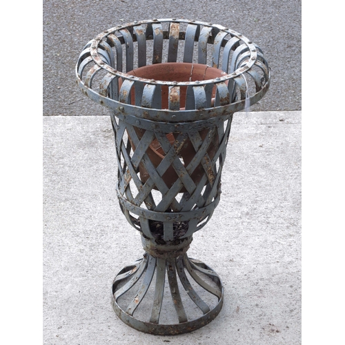 954 - A wrought iron campana garden urn, of strapwork design, 65cm high.