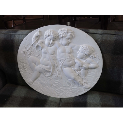 959 - A cast plaster oval depicting cherubs, 60 by 70cm