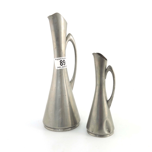 89 - A graduated pair of Norwegian Modernist pewter jugs, Brodrene Mylius, trumpet form with whiplash han... 